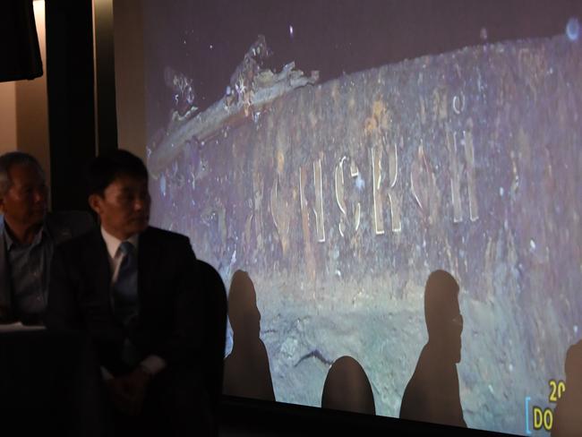 Choi Yong-seok (2nd L), CEO of Shinil Group, looks at a video footage taken by a submersible of the wreck, with the word "Donskoi" visible on the hull. Picture: AFP