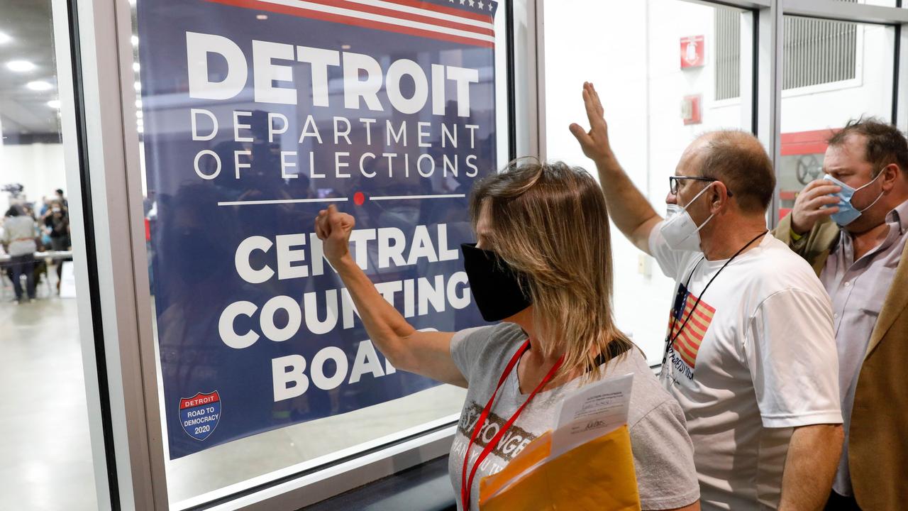 Pro-Trump supporters bang on the glass and chant slogans outside the room where absentee ballots were being counted at Detroit’s TCF Centre. Picture: Jeff Kowalsky/AFP