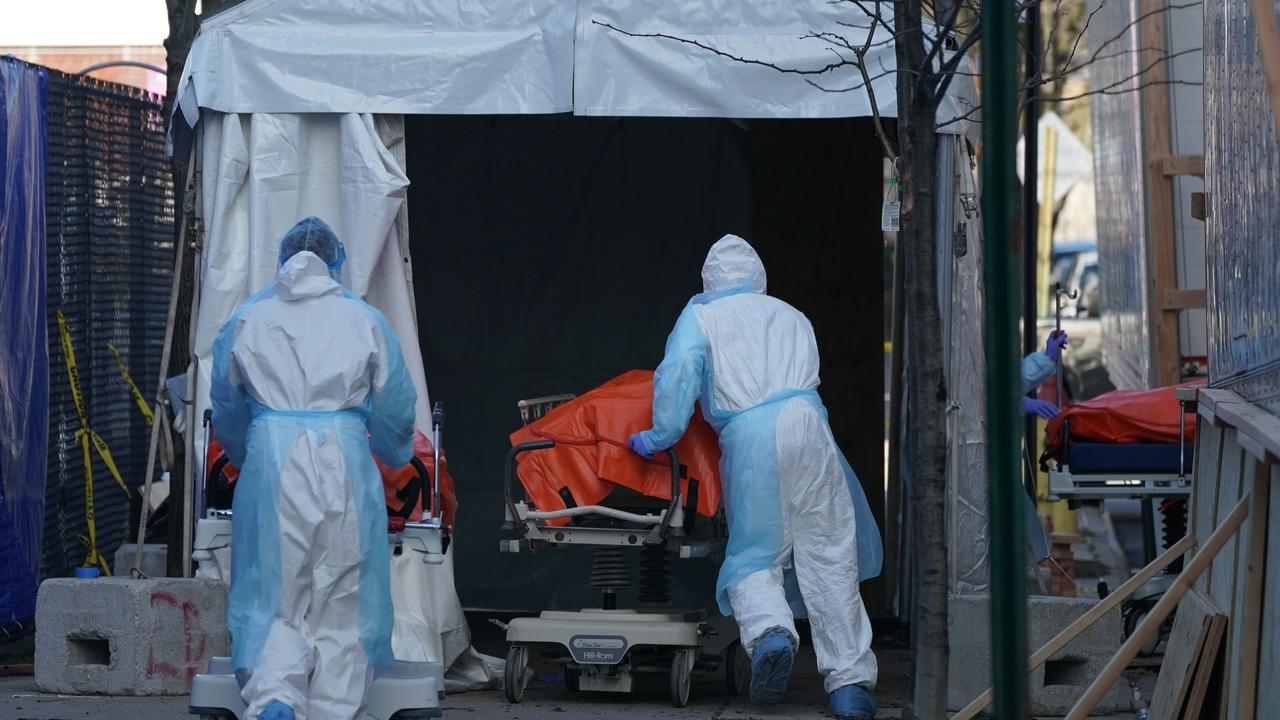 A body is moved into the truck. Picture: Bryan R. Smith/AFP