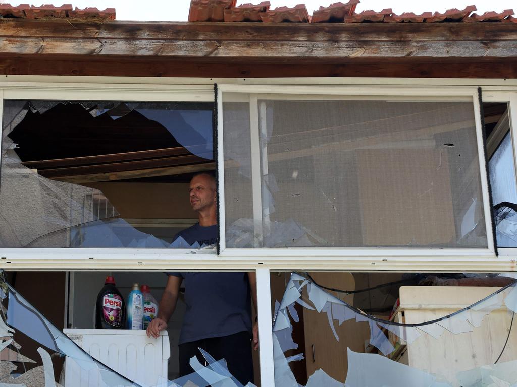 A resident checks the damage caused by a strike from Lebanon in the Israeli coastal town of Acre. Picture: AFP