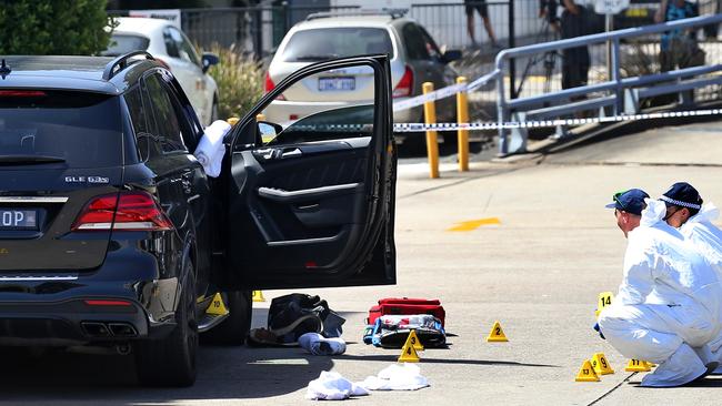 Forensic crews collect evidence from the scene of hawi’s murder. Picture: Toby Zerna