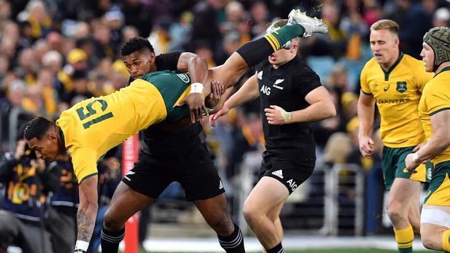 New Zealand’s Waisake Naholo tackles Australia’s Israel Folau.