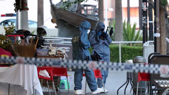 Forensic officers at the murder scene yesterday. Picture: David Swift