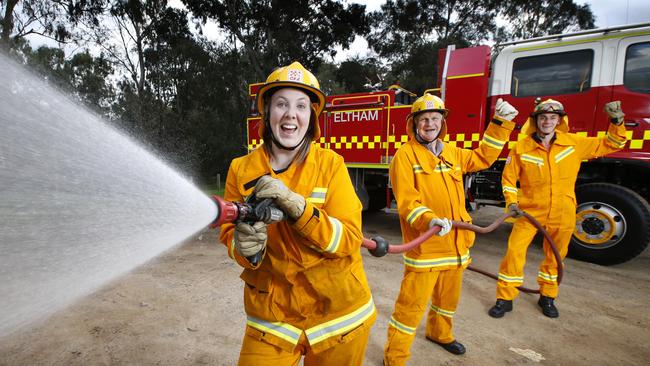 Eltham CFA firefighters Lizzy Wade, Clem Egan and Rhys Trevithick fire up with the good news. Picture: David Caird