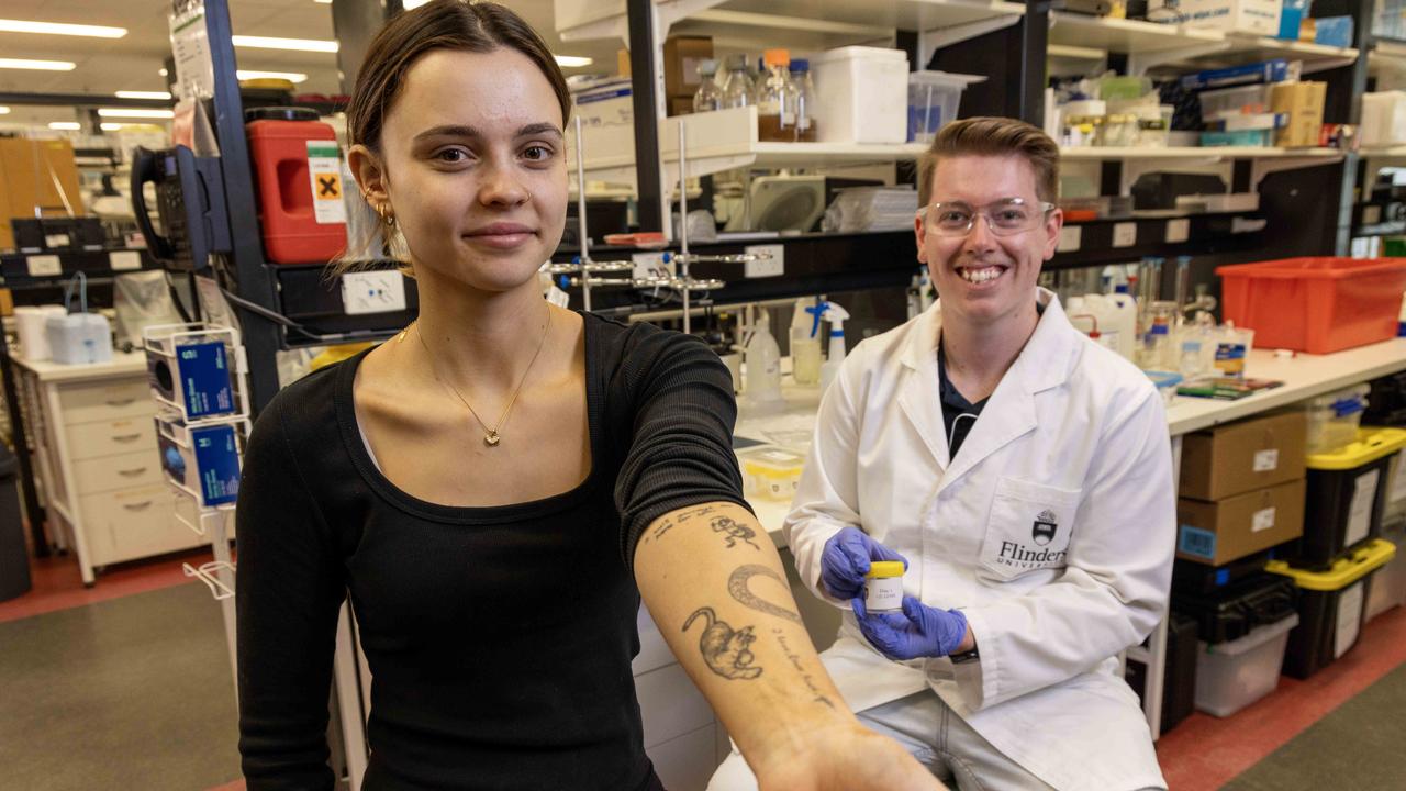 Lexi Dignam with Flinders University PhD candidate Benjamin Boyle, who is researching potential health risks of tattoo removal Picture: Kelly Barnes