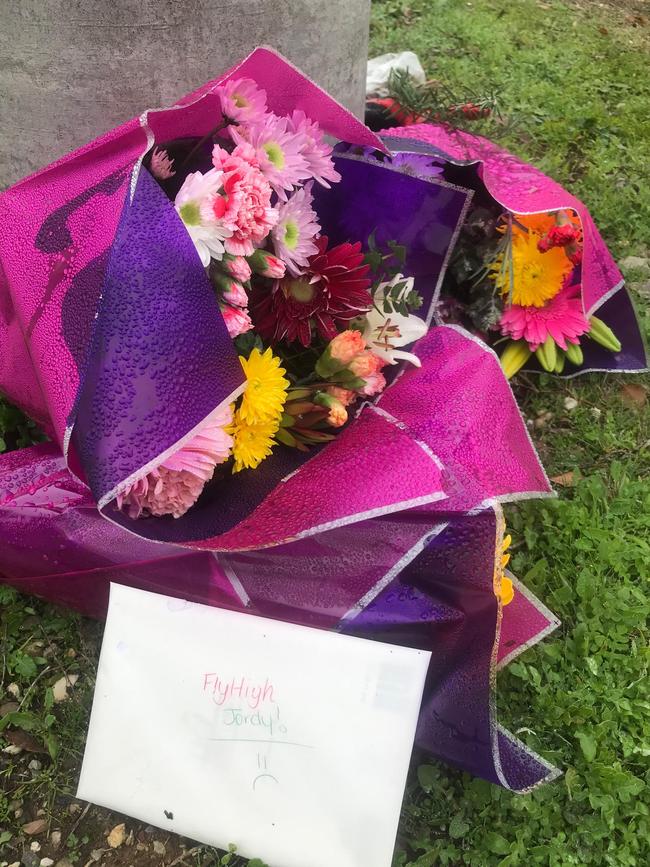 Flowers left at the scene of a hit-run crash that killed Jordan Purcell.