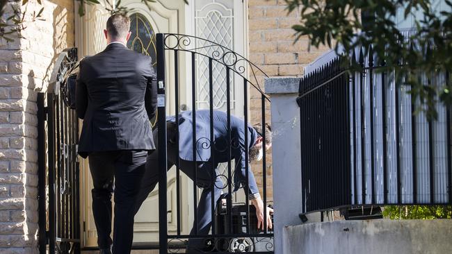 AFP officers during the raid at Mr Moselmane’s home. Picture: Dylan Robinson