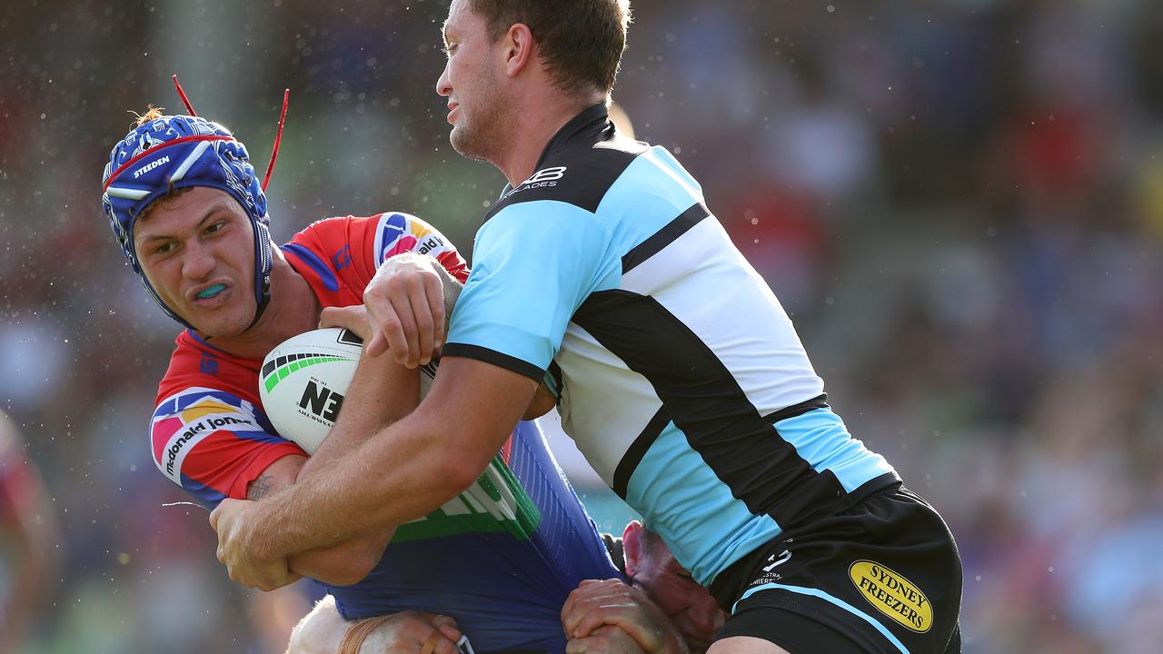 Kalyn Ponga of the Newcastle Knights is tackled in the trial with Cronulla 