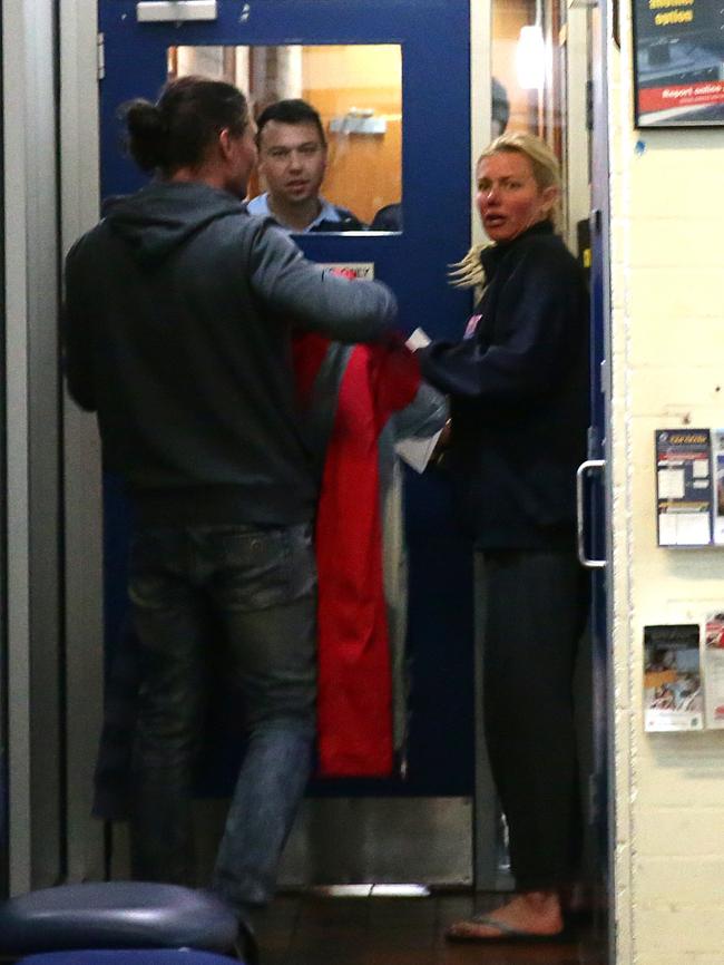 Buttrose and Stopar try and get back into the police station. Picture: Bill Hearne