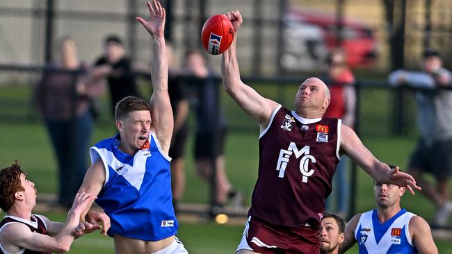 Sunbury’s Jayden Eales and Melton’s Brett McIntyre contest the ruck. Picture: Andy Brownbill