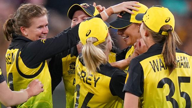 Jess Jonassen and Ashleigh Gardner are congratulated by their teammates after taking a wicket during the final against India. Picture: AAP Image/Scott Barbour