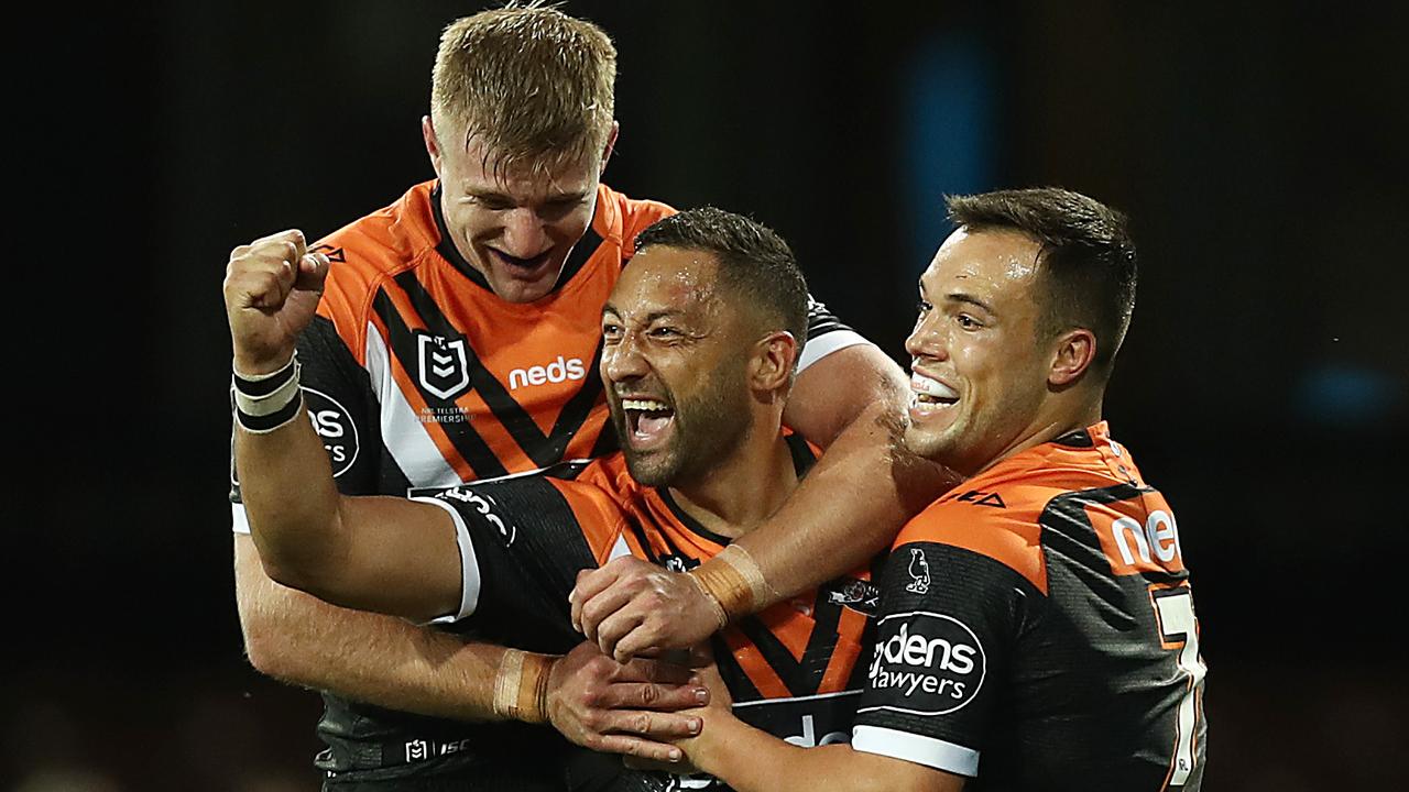 Benji Marshall (centre) has re-signed with Wests Tigers.