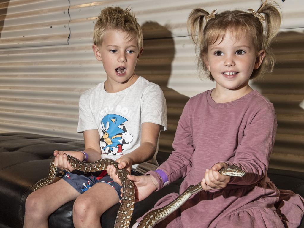 Lewis 7yo and Lola 3yo Harrison with Nutella the Bredli python. Cobb+Co Museum Easter school holiday program Wildlife Rangers with Wildcall Wildlife Shows. Monday, April 4, 2022. Picture: Nev Madsen.