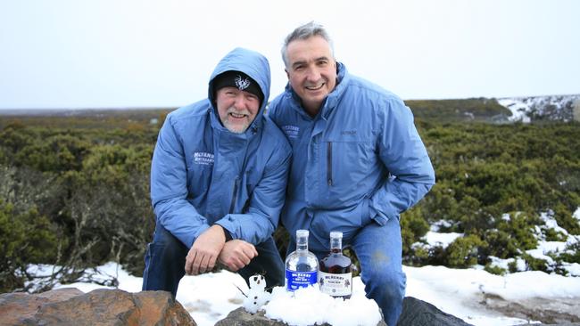 Distillers Bill Ravenscroft, left, and Bill McHenry, both of McHenry Distillers, show off some of their top drops at the snowy weekend retreat. Picture: AMANDA DUCKER