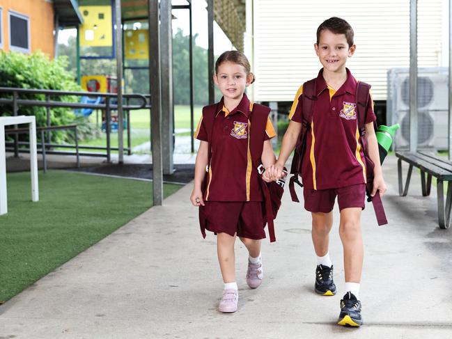 Max Thomas, 6, walks his sister Lyla Thomas, 4, to her prep class on her first day at Edge Hill State School. Picture: Brendan Radke