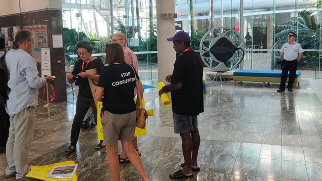 A single police officer watched over the protest at the Cairns Regional Council chambers.