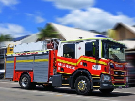 AIRLIE BEAH, QLD - OCT 02 2022:Australian firetruck rushing to scene.The global fire trucks market size was estimated at USD 4.30 billion in 2015.