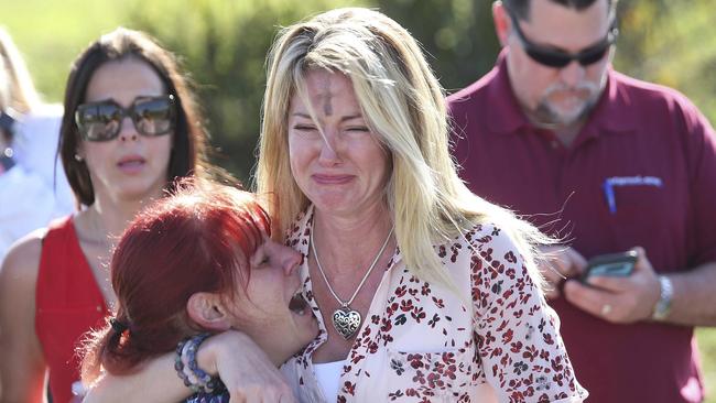 Parents wait for news outside the Marjory Stoneman Douglas High School in Parkland. Picture: PA.