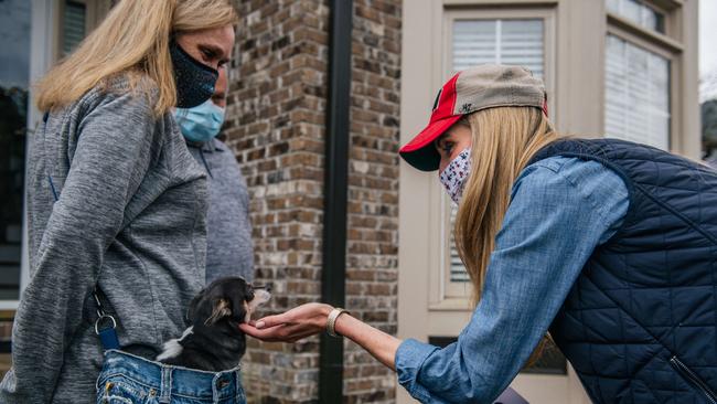 Kelly Loeffler meets creatures great and small while door knocking in Loganville, Georgia, on Sunday. Picture: AFP