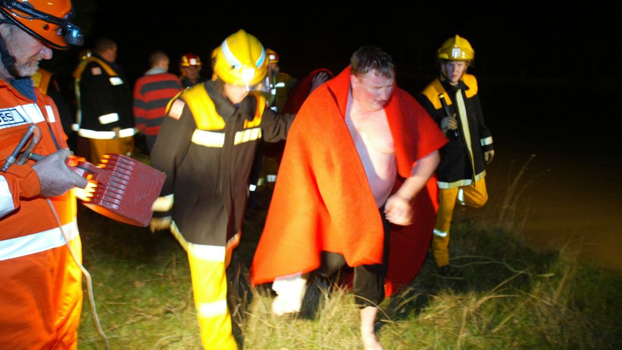 A CFA diver is helped from the dam after searching for the three boys near Winchelsea.