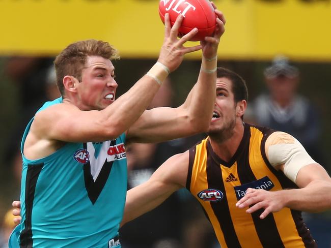 Port Adelaide’s Brett Eddy wins the ball in front of Hawthorn’s Ben Stratton in their JLT series match in Noarlunga. Picture: Getty Images