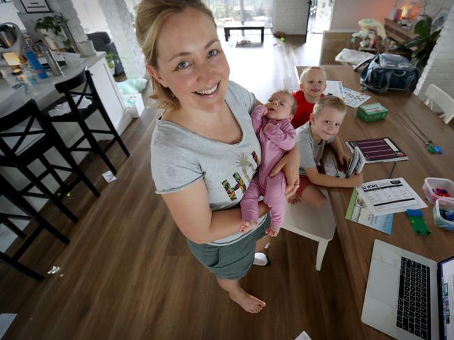 Claire Cameron with her children Ollie 6 Cooper 4.5 and Matilda 7 weeks said home schooling as set by the schools was too much to expect of parents. Queensland schools went back this week. Picture: Jamie Hanson