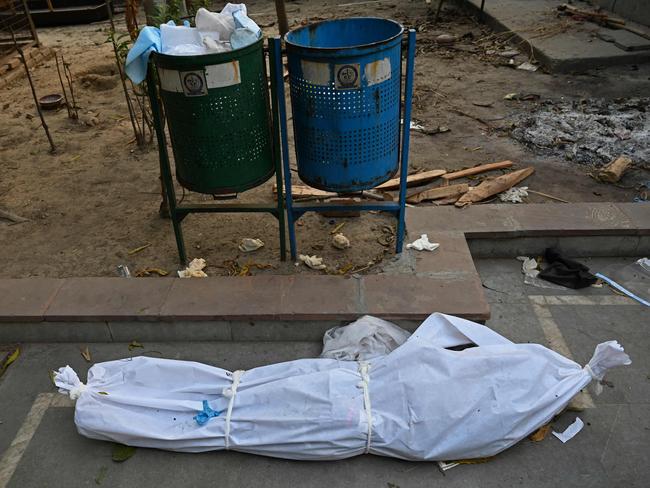 The body of a coronavirus victim lies at a cremation ground. Picture: AFP