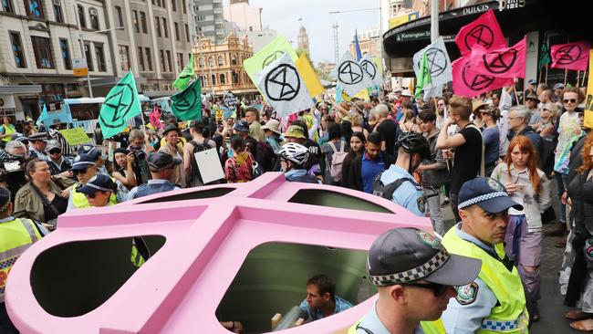 Protesters locked themselves in a water tank on Sydney’s streets. Picture: Richard Dobson