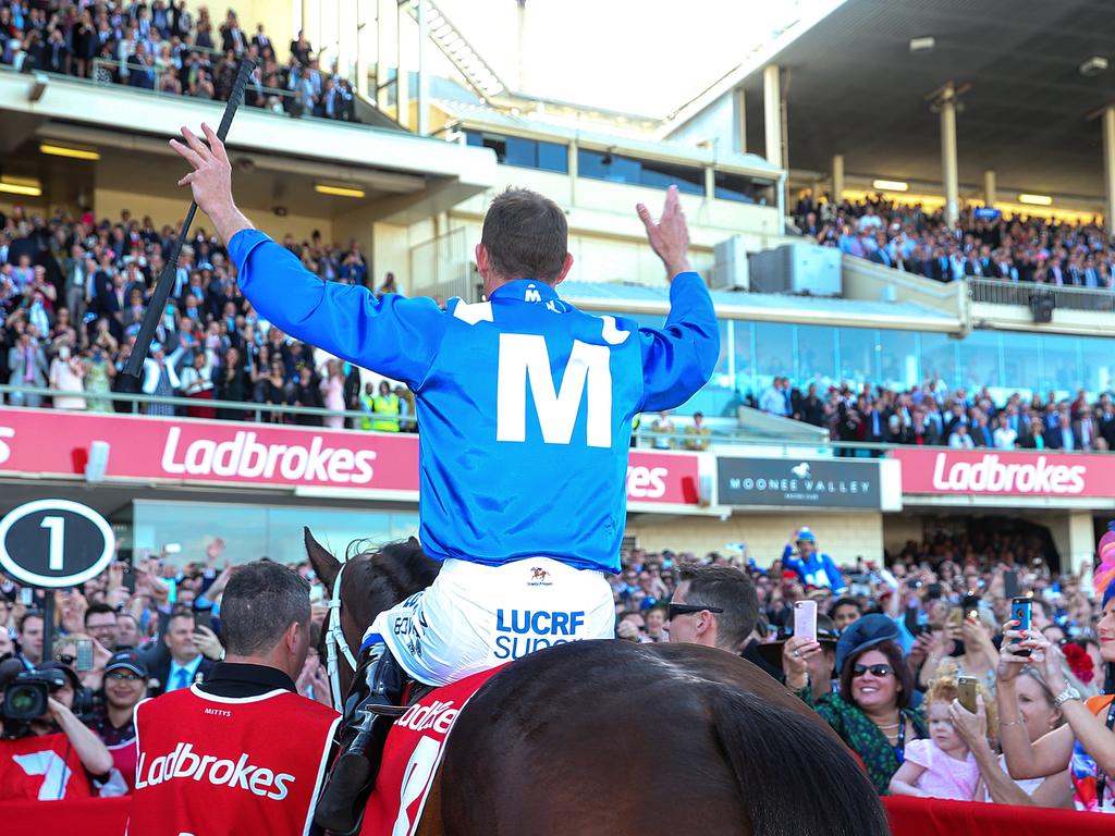 Legend status guaranteed: Jockey Hugh Bowman acknowledges the Moonee Valley crowd after Winx’s record-equalling third Cox Plate. Picture : Ian Currie