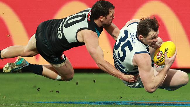 Patrick Dangerfield and Travis Boak go at it. Picture: Kelly Defina/Getty Images