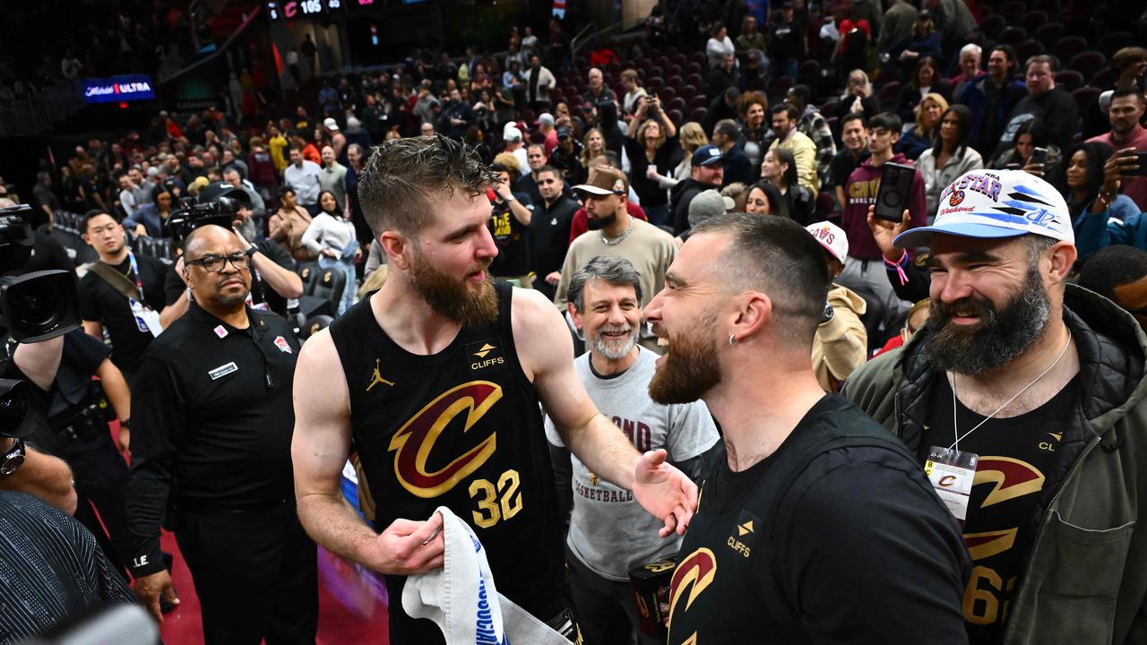 Dean Wade #32 of the Cleveland Cavaliers talks with Travis and Jason Kelce after the game.