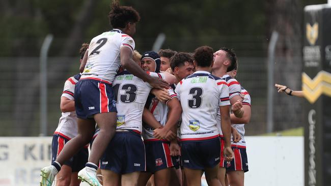 The Roosters celebrate a try. Picture: Sue Graham