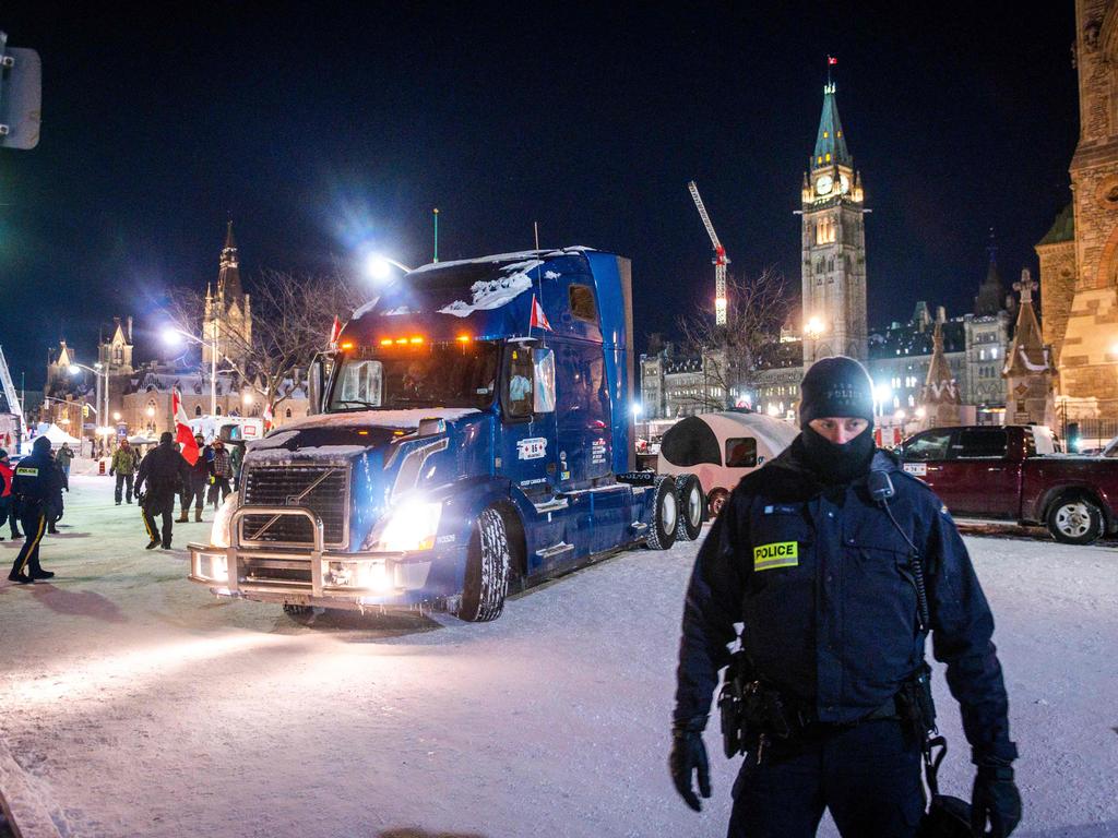 A police officer stands by as a truck leaves Parliament Hill during a trucker-led protest over pandemic health rules and the Trudeau government, in Ottawa. Picture: AFP