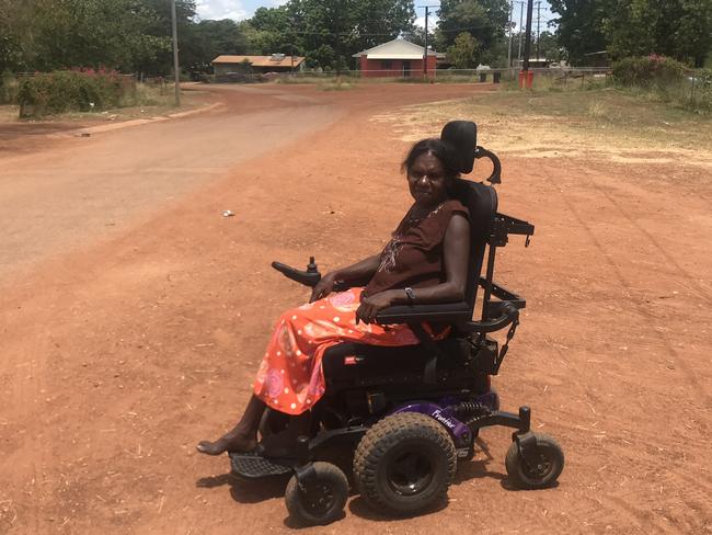 NDIS recipient Bronwyn Daniels pictured near her home in Ngukurr, NT. Ms Daniels has severe-stage Machado-Joseph Disease and is assisted by the MJD Foundation.