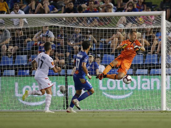 Nikola Mileusnic of United takes an opportunity to score a first half goal by swooping on a loose ball from Jets keeper  Glen Moss during the Round 10 A-League match between the Newcastle Jets and Adelaide United at McDonald Jones Stadium in Newcastle, Sunday, December 30, 2018. (AAP Image/Darren Pateman) NO ARCHIVING, EDITORIAL USE ONLY