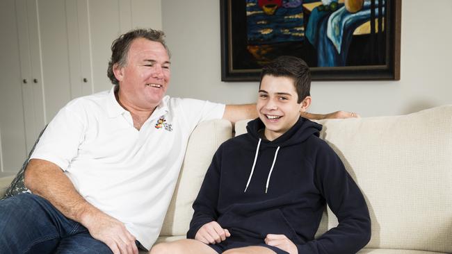 12-year-old cancer patient Hugo Kulscar with Wallabies legend Owen Finegan, who is auctioning off his signed jerseys from Australia's 1999 World Cup win and Brumbies 2001 Super Rugby victory to raise funds for The Kids Cancer Project. Picture: Dylan Robinson