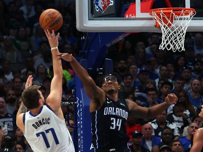 DALLAS, TEXAS - OCTOBER 30: Luka Doncic #77 of the Dallas Mavericks puts up a shot over Wendell Carter Jr. #34 of the Orlando Magic in the first haf at American Airlines Center on October 30, 2022 in Dallas, Texas. NOTE TO USER: User expressly acknowledges and agrees that, by downloading and/or using this Photograph, user is consenting to the terms and conditions of the Getty Images License Agreement.   Richard Rodriguez/Getty Images/AFP