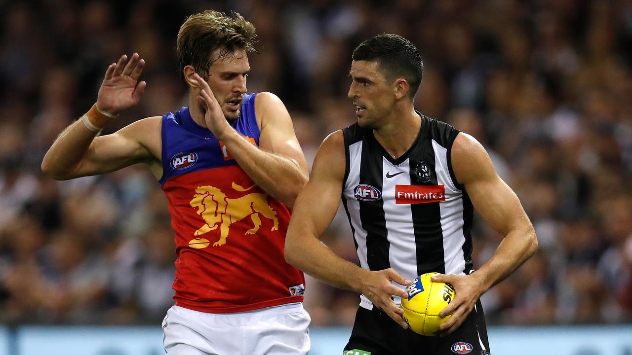 Scott Pendlebury and Grant Birchall in action on Thursday night of Round 3.