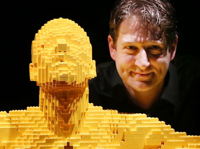 THE ART OF BRICK EXHIBITION .. LONDON, ENGLAND - SEPTEMBER 24: Artist Nathan Sawaya stands with his sculpture 'Yellow' at the Art of Brick Exhibition on September 24, 2014 in London, England. Eighty sculptures by artist Nathan Sawaya are on display at The Old Truman Brewery. Created from a million Lego bricks, the exhibition opens on September 26, 2014 and runs until January 4, 2015. (Photo by Peter Macdiarmid/Getty Images)