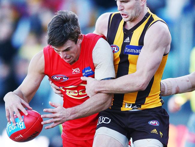 Luke Breust of the Hawks lays a tackle on Jarryd Lyons of the Suns during the round 14 AFL match between the Hawthorn Hawks and the Gold Coast Suns at University of Tasmania Stadium. Picture: Michael Dodge, Getty Images.