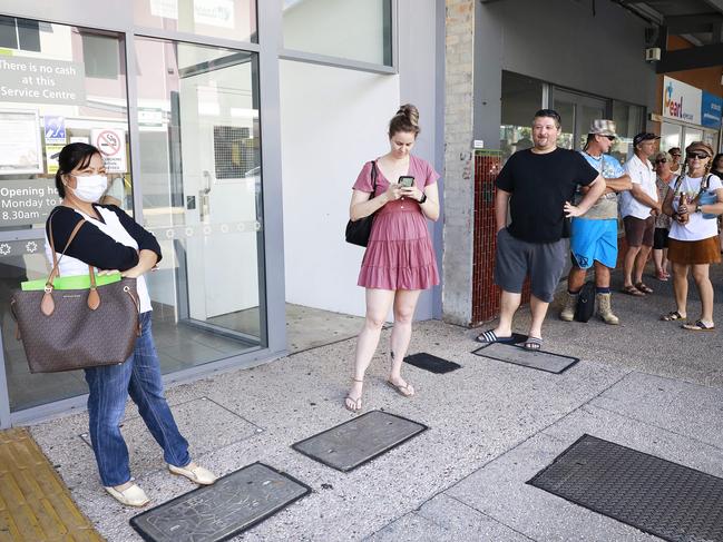 Mila McKenzie, Kirstin Russell and Tim Wrigley stand outside Centrelink in Nundah, Brisbane last week. Picture: AAP