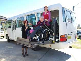 Harry Potts rides the lift on Byron Aged Care's new bus accompanied by activities officer Lyn McBurney (right) and CEO Margaret Geoghegan. Picture: Christian Morrow