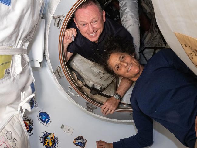 This undated handout picture from Nasa released on July2, 2024 shows NASAâs Boeing Crew Flight Test astronauts (from top) Butch Wilmore and Suni Williams inside the vestibule between the forward port on the International Space Stationâs Harmony module and Boeing's Starliner spacecraft. The first astronauts to fly Boeing's troubled Starliner are definitely not 