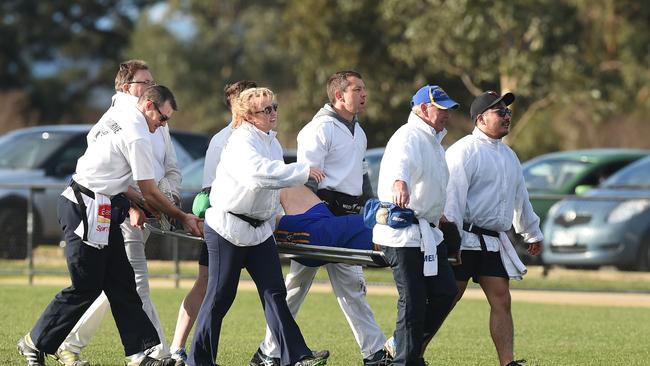 Season over: Marc Holt is carried off on a stretcher with a broken leg this year. Picture: Chris Eastman