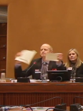 Dr Damian Adams tears up his original birth certificate at the end of his speech.