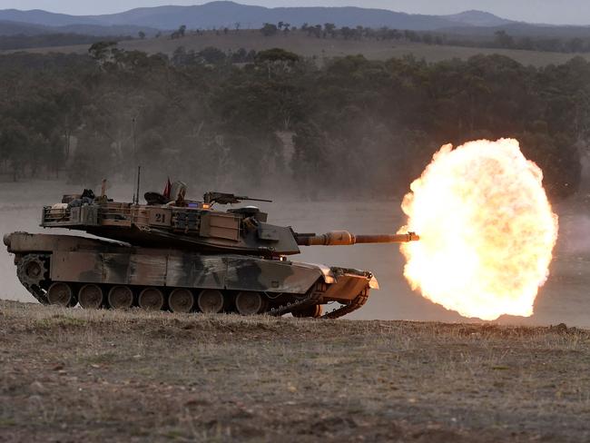 (FILES) A file photo taken on May 9, 2019 shows an Australian Army M1A1 Abrams main battle tank firing a round at a target during Excercise Chong Ju, a live fire demonstration showcasing the army's joint combined arms capabilities, at the Puckapunyal Military Base some 100 kilometres north of Melbourne. - Australia launched its biggest defence shakeup in decades on April 24, 2023, vowing to turn a military that is "no longer fit for purpose" into a fighting force that could deter China or any would-be foe. (Photo by William WEST / AFP)