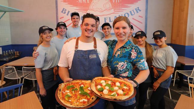 Head Chef Stefano Mauro and store General Manager Karoliin Palmist with staff and pizza. Picture: Glenn Hampson