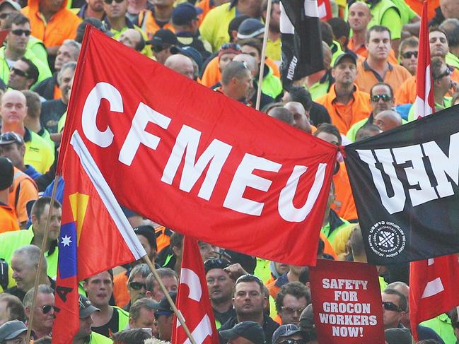 MELBOURNE, AUSTRALIA - APRIL 30: Construction workers march past the Myer Emporium site during the Grocon Rally and March on April 30, 2013 in Melbourne, Australia. The Construction, Forestry, Mining and Energy Union (CFMEU) organised the protest calling for building giant Grocon to improve its safety standards. (Photo by Scott Barbour/Getty Images)