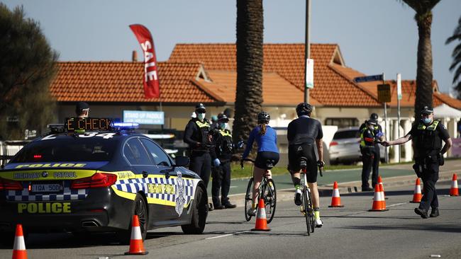 Police check licences of cyclists along St Kilda Beach in Melbourne. Picture: Daniel Pockett