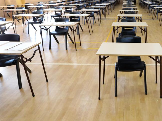 series of views of an examination hall or room images with exam tables set up ready for students. empty chairs and tables.   End of school exams university entrance or higher school certificate scene.